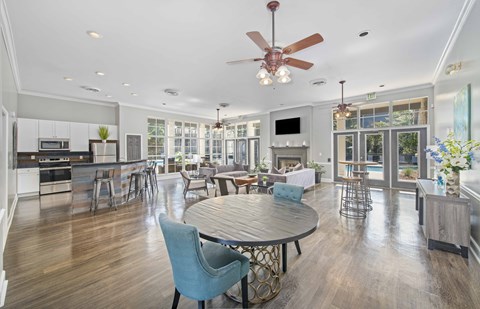 a living room with a dining room and a kitchen with a table and chairs